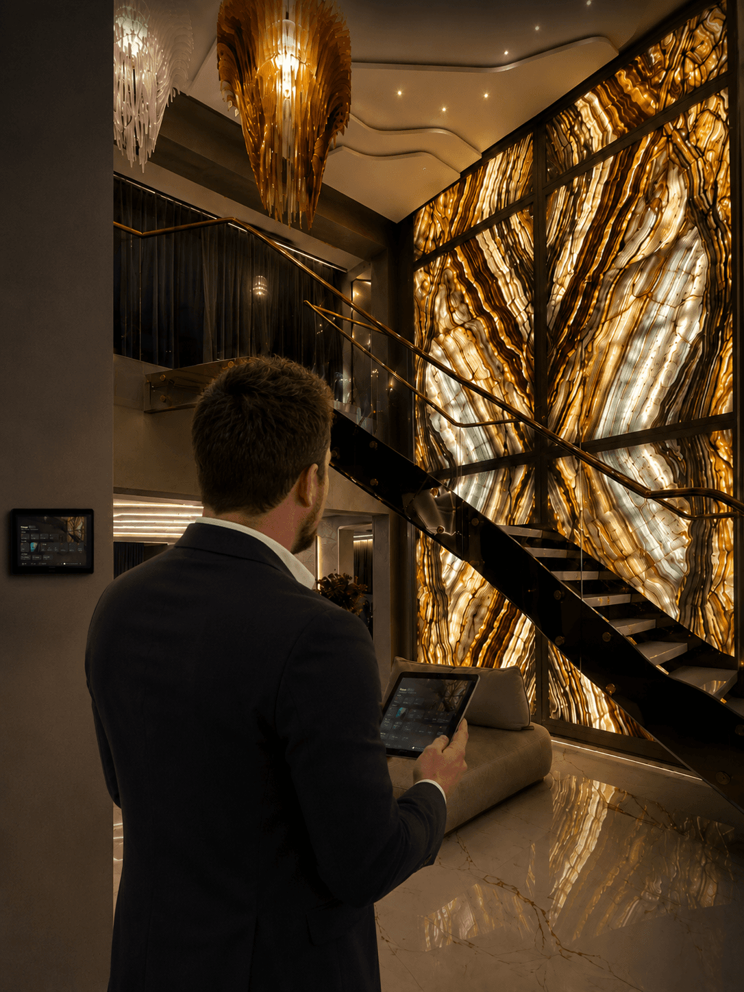 David Morel reviewing a backlit onyx feature wall and Crestron control interface