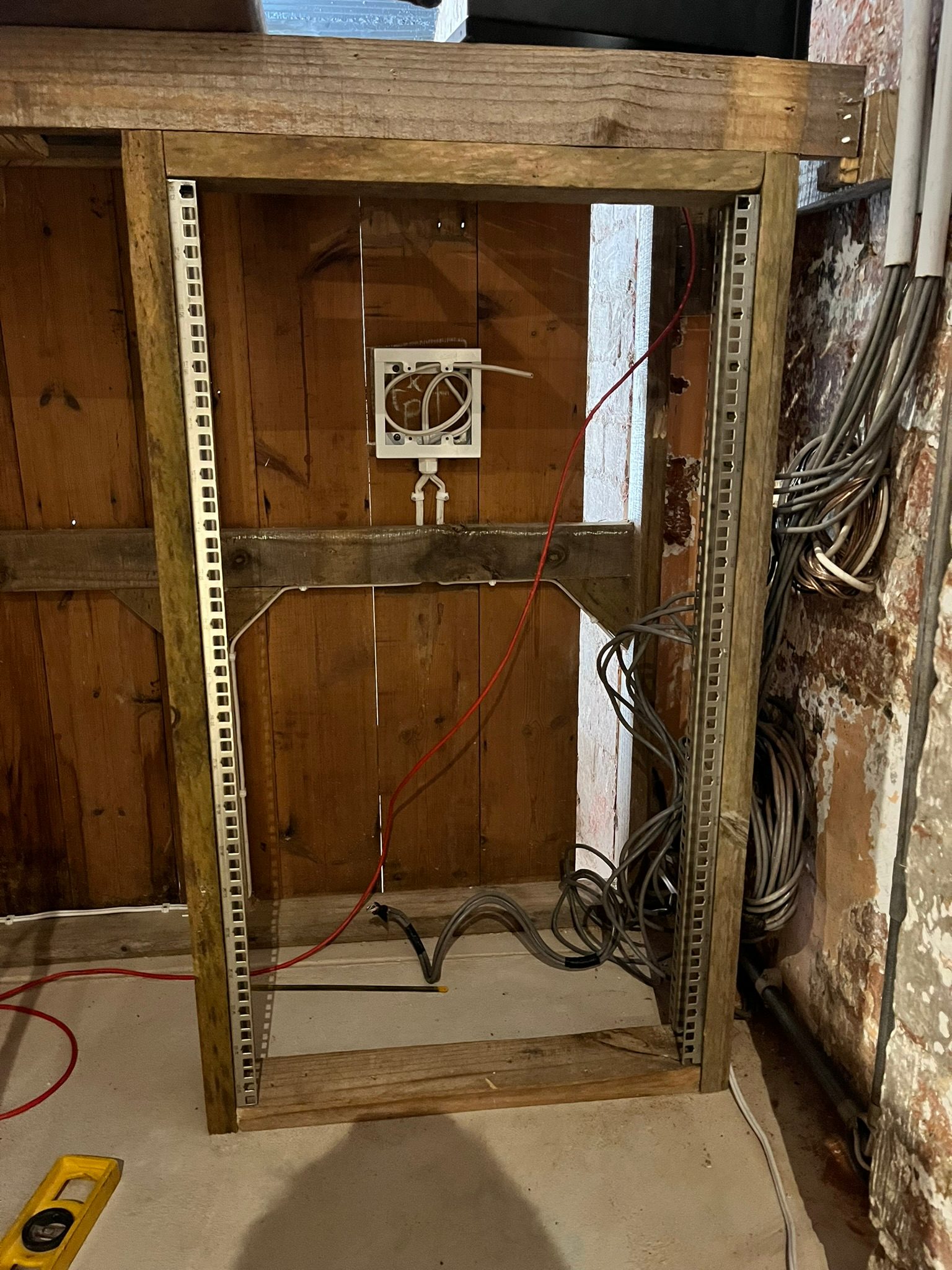 AV equipment rack built into a custom bar where power and equipment choices must be planned carefully