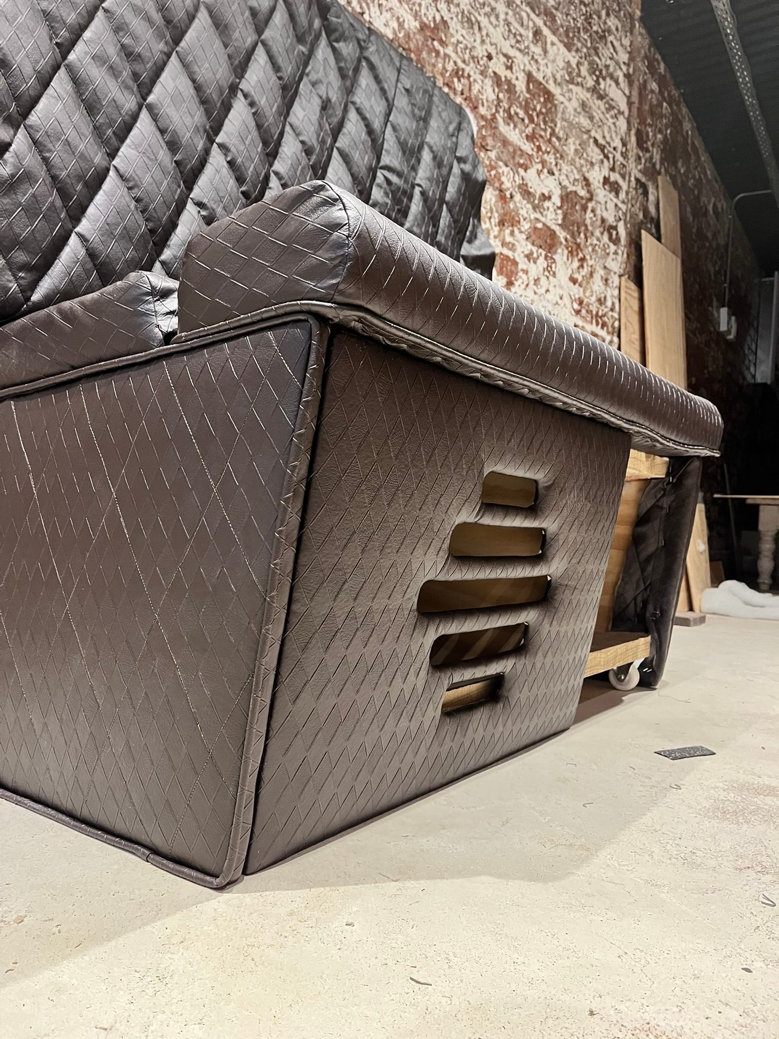 Custom hidden subwoofer vent built into upholstered seating