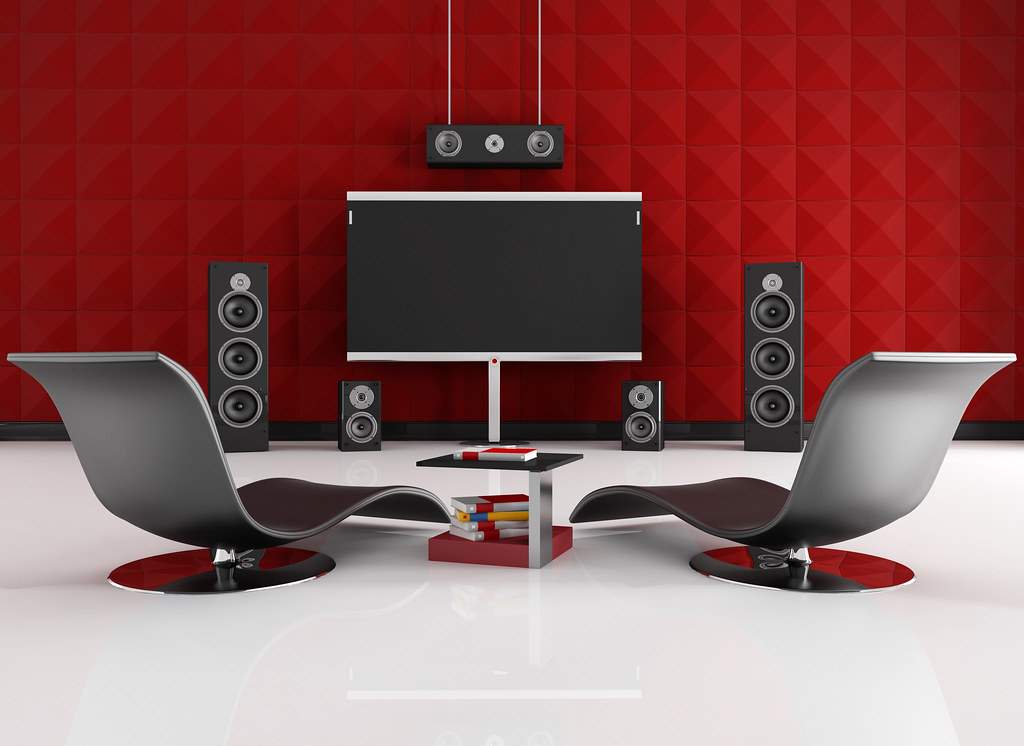 Dedicated home cinema room with screen, speakers and acoustic wall treatment