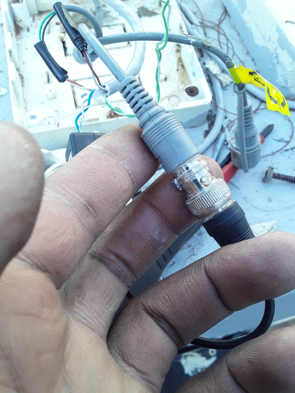 Close inspection of weather-damaged CCTV connector during fault finding